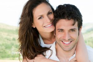 woman hugging man, both smiling