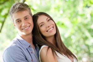 image of a man and a woman smiling and leaning on each other